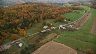 5.5K aerial stock footage flying by Boudro Road, rural farms, foliage in autumn, Randolph Center, Vermont Aerial Stock Footage | AX150_409