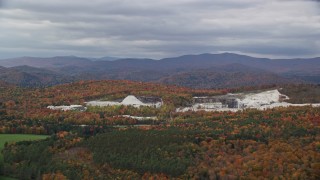 5.5K aerial stock footage flying by a colorful forest, quarry, autumn, overcast, Bethel, Vermont Aerial Stock Footage | AX150_419E