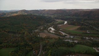 5.5K aerial stock footage flying over trailers, approaching White River, Route 107 in autumn, South Royalton, Vermont Aerial Stock Footage | AX150_423E