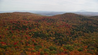 5.5K aerial stock footage flying over colorful, densely forested hills in autumn, North Pomfret, Vermont Aerial Stock Footage | AX150_461E