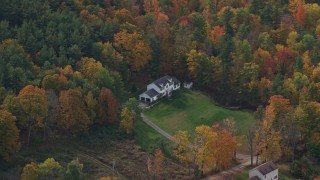 5.5K aerial stock footage flying by rural homes, lawns, brightly colored trees in autumn, Quechee, Vermont Aerial Stock Footage | AX150_471