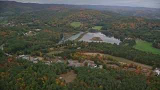 5.5K aerial stock footage flying by Dewey's Pond, rural homes, autumn, overcast, Quechee, Vermont Aerial Stock Footage | AX151_005