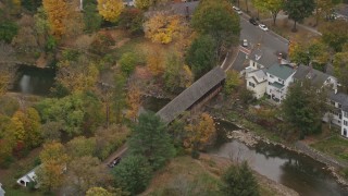 5.5K aerial stock footage orbiting a small covered bridge, Ottauquechee River, autumn, Woodstock, Vermont Aerial Stock Footage | AX151_020E