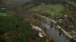 5.5K aerial stock footage flying over colorful forest, approach farms, small rural town, autumn, Taftsville, Vermont Aerial Stock Footage | AX151_025E