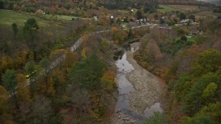 5.5K aerial stock footage approaching small covered bridge across Ottauquechee River, autumn, Taftsville, Vermont Aerial Stock Footage | AX151_028E