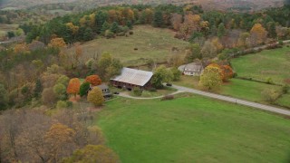 5.5K aerial stock footage orbiting small farm, barn, grass clearings, colorful foliage in autumn, Taftsville, Vermont Aerial Stock Footage | AX151_033