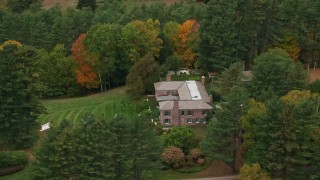 5.5K aerial stock footage flying by colorful trees, revealing isolated mansion, autumn, Cornish, New Hampshire Aerial Stock Footage | AX151_051E