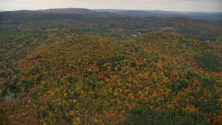 5.5K aerial stock footage flying by brightly colored forested hills, autumn, overcast, Cornish, New Hampshire Aerial Stock Footage | AX151_067