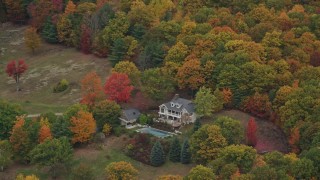 5.5K aerial stock footage flying away from isolated homes, brightly colored trees, autumn, Cornish, New Hampshire Aerial Stock Footage | AX151_068