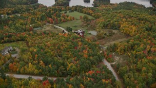 5.5K aerial stock footage flying over mansion, approach small islands, Lake Sunapee, autumn, Sunapee, New Hampshire Aerial Stock Footage | AX151_081