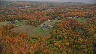 5.5K aerial stock footage flying by rural home, colorful trees, autumn, New London, New Hampshire Aerial Stock Footage | AX151_095