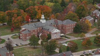 AX151_100 - 5.5K aerial stock footage orbiting Colgate Hall, Colby Sawyer College, autumn, New London, New Hampshire