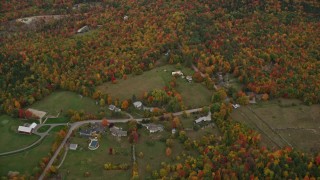 5.5K aerial stock footage approaching rural homes, overcast skies, colorful trees, autumn, Wilmot, New Hampshire Aerial Stock Footage | AX151_109E