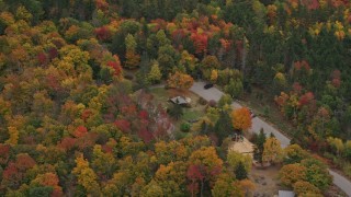 5.5K aerial stock footage flying by parking area, brightly colored forrest, autumn, Wilmot, New Hampshire Aerial Stock Footage | AX151_111