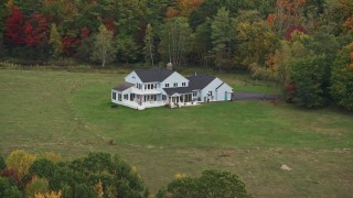 5.5K aerial stock footage flying by an isolated home, colorful foliage in autumn, Webster, New Hampshire Aerial Stock Footage | AX151_129