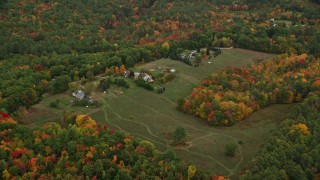 5.5K aerial stock footage approaching rural homes, grassy clearing, tilt down, autumn, Penacook, New Hampshire Aerial Stock Footage | AX151_140