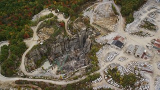 AX151_168E - 5.5K aerial stock footage orbiting fall foliage, quarry, autumn, Concord, New Hampshire