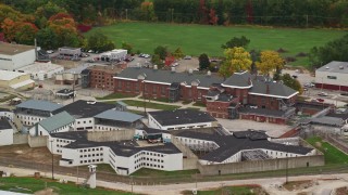 AX151_172E - 5.5K aerial stock footage flying by the New Hampshire State Prison in autumn, Concord, New Hampshire