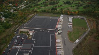 5.5K aerial stock footage flying over colorful trees, approach office buildings, autumn, Pembroke, New Hampshire Aerial Stock Footage | AX152_002E