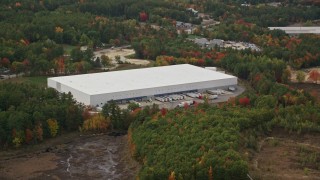 5.5K aerial stock footage flying by large warehouse building, colorful foliage, autumn, Bow, New Hampshire Aerial Stock Footage | AX152_007