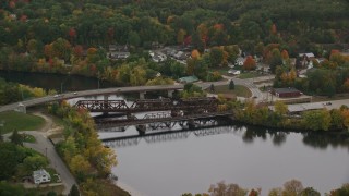 AX152_014 - 5.5K aerial stock footage orbiting small bridges, Merrimack River, autumn, Hooksett, New Hampshire