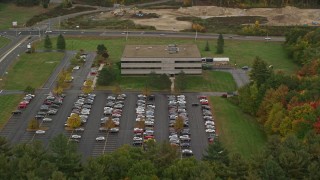 5.5K aerial stock footage approaching an office building, tilt down, autumn, Hooksett, New Hampshire Aerial Stock Footage | AX152_018