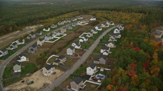 5.5K aerial stock footage flying by tract homes, colorful foliage in autumn, Hooksett, New Hampshire Aerial Stock Footage | AX152_020