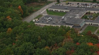 AX152_025 - 5.5K aerial stock footage flying by Hooksett Memorial School, colorful foliage, autumn, Hooksett, New Hampshire