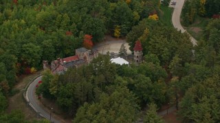 5.5K aerial stock footage flying away from Searles Castle, trees, autumn, Windham, New Hampshire Aerial Stock Footage | AX152_069