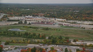 AX152_080E - 5.5K aerial stock footage flying by Rockingham Park, colorful foliage in autumn, overcast, Salem, New Hampshire