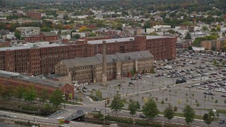 5.5K aerial stock footage flying by factories, smoke stacks, colorful foliage, autumn, Lawrence, Massachusetts Aerial Stock Footage | AX152_094