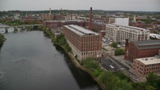 5.5K aerial stock footage flying over Duck Bridge, pan right by factories, autumn, Lawrence, Massachusetts Aerial Stock Footage | AX152_095