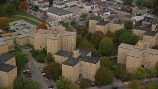 5.5K aerial stock footage flying by urban apartment buildings among partial fall foliage, Lowell, Massachusetts Aerial Stock Footage | AX152_139E