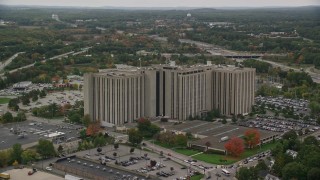 5.5K aerial stock footage flying by office building and parking lot, autumn, Lowell, Massachusetts Aerial Stock Footage | AX152_144