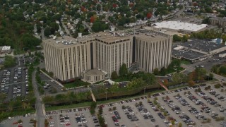 5.5K aerial stock footage orbiting away from an office building and parking lots, autumn, Lowell, Massachusetts Aerial Stock Footage | AX152_145E