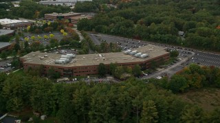 5.5K aerial stock footage approaching and orbiting away from office building and partial fall foliage, Chelmsford, Massachusetts Aerial Stock Footage | AX152_149