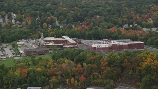 5.5K aerial stock footage approaching a prison surrounded by partial fall foliage, autumn, Billerica, Massachusetts Aerial Stock Footage | AX152_152