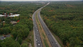 5.5K aerial stock footage following a highway bordered by fall foliage toward an overpass, Billerica, Massachusetts Aerial Stock Footage | AX152_162E