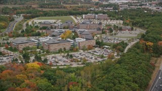 5.5K aerial stock footage flying by parking lots and office buildings among fall foliage, Burlington, Massachusetts Aerial Stock Footage | AX152_165