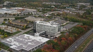 5.5K aerial stock footage flying away from office buildings and parking lots, autumn, Burlington, Massachusetts Aerial Stock Footage | AX152_167