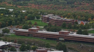 5.5K aerial stock footage flying by office buildings, colorful foliage, autumn, overcast, Waltham, Massachusetts Aerial Stock Footage | AX152_175