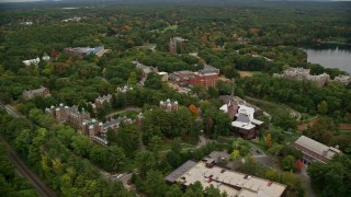 AX152_184E - 5.5K aerial stock footage orbiting Wang Campus Center, overcast, autumn, Wellesley College, Massachusetts