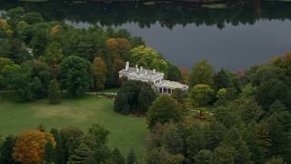 5.5K aerial stock footage flying by mansion near the lake, autumn, Wellesley, Massachusetts Aerial Stock Footage | AX152_187