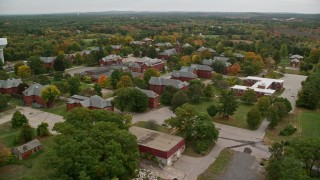 AX152_195E - 5.5K aerial stock footage orbiting Medfield State Hospital among fall foliage, autumn, Medfield, Massachusetts