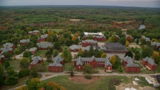 5.5K aerial stock footage flying by water tower and Medfield State Hospital among fall foliage, Medfield, Massachusetts Aerial Stock Footage | AX152_198E