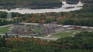 5.5K aerial stock footage of a slow approach over fall foliage toward Massachusetts Correctional Institution at Norfolk, Massachusetts Aerial Stock Footage | AX152_210E