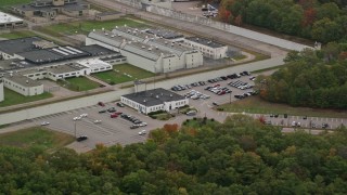 AX152_215 - 5.5K aerial stock footage flying by buildings at Massachusetts Correctional Institution Cedar Junction, autumn, Walpole, Massachusetts