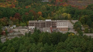 5.5K aerial stock footage flying over fall foliage toward abandoned hospital, Walpole, Massachusetts Aerial Stock Footage | AX152_219