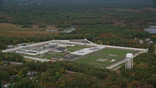 5.5K aerial stock footage flying over trees with fall foliage along the Massachusetts Correctional Institution Cedar Junction, Walpole, Massachusetts Aerial Stock Footage | AX152_222E