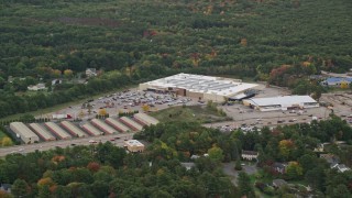 5.5K aerial stock footage flying by Walmart, surrounded by trees with partial fall foliage, Walpole, Massachusetts Aerial Stock Footage | AX152_232